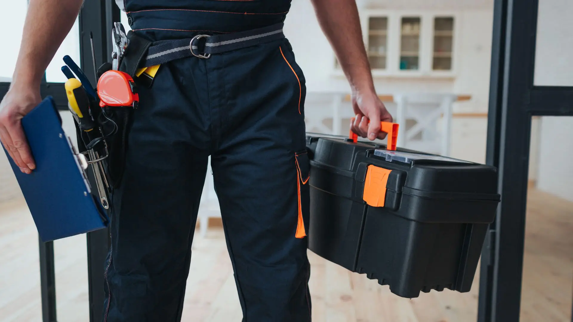 Worker carrying toolbox and clipboard