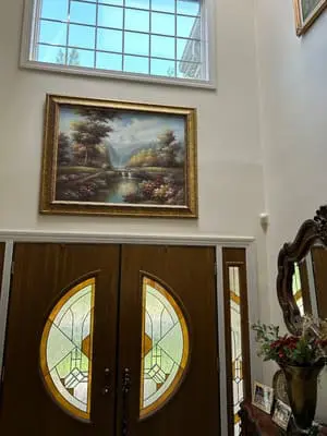 Home entryway with landscape painting
