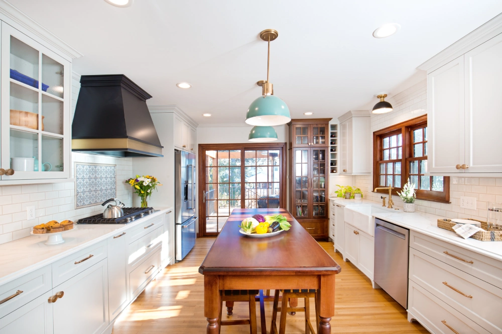 Bright kitchen with wooden dining table and modern appliances.